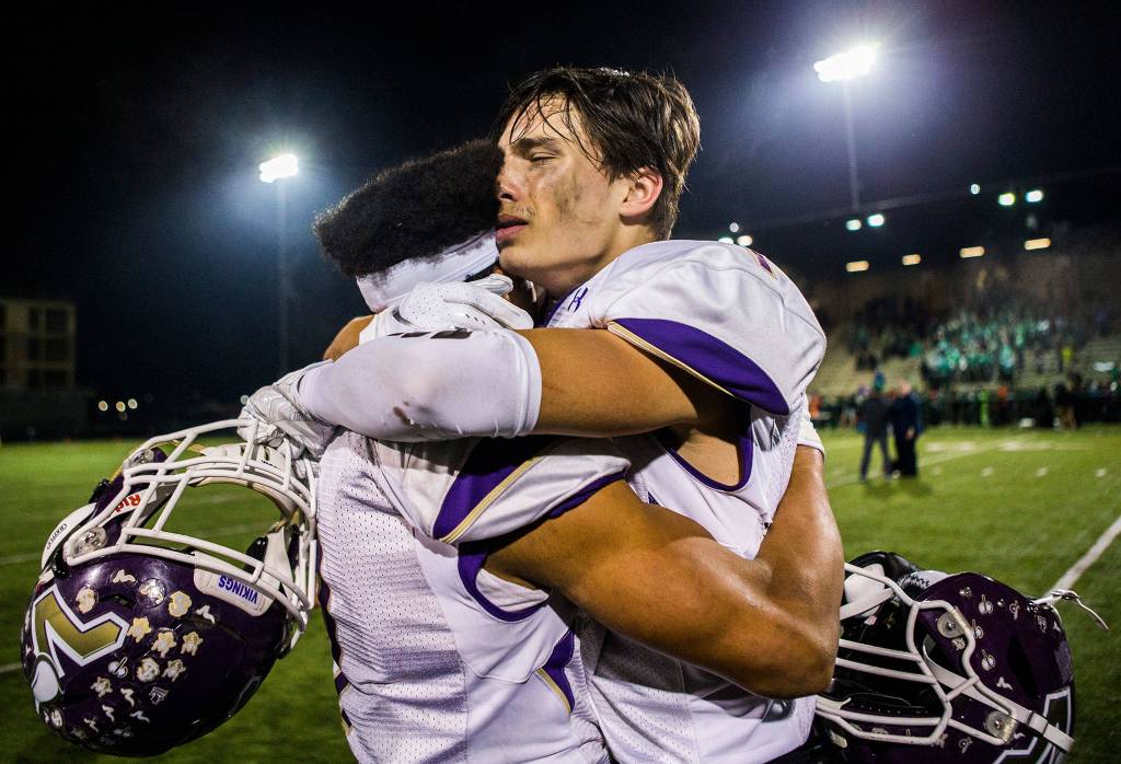 Lake Stevens Ian Hanson, right, hugs Isaiah Harris after winning the Class 4A state state semifinal game against Woodinville at Pop Keeney Stadium on Saturday, Nov. 24, 2018 in Bothell, Wa. (Olivia Vanni / The Herald)