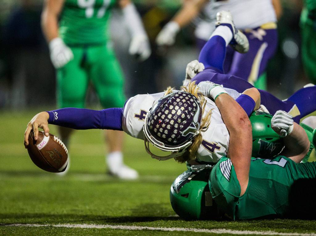 Lake Stevens Tre Long reaches across the goal line for a touchdown during the Class 4A state state semifinal game against Woodinville at Pop Keeney Stadium on Saturday, Nov. 24, 2018 in Bothell, Wa. (Olivia Vanni / The Herald)