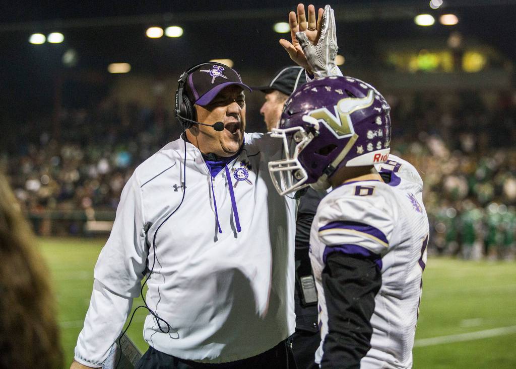 Lake Stevens head coach Tom Tri high fives Dallas Landeros during the Class 4A state state semifinal game against Woodinville at Pop Keeney Stadium on Saturday, Nov. 24, 2018 in Bothell, Wa. (Olivia Vanni / The Herald)