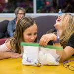 Zoe Charlebois (left) and Makayla Goshen, both 10, make their friendship first aid kits during an InspireHER event at the Snohomish Boys & Girls Club. (Olivia Vanni / The Herald)