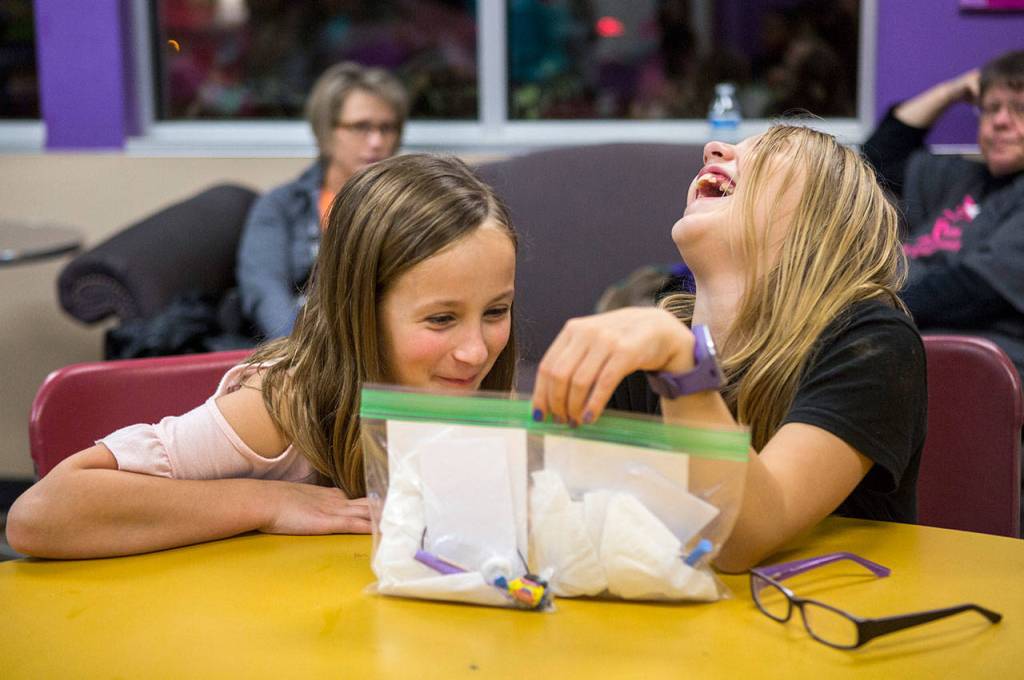Zoe Charlebois (left) and Makayla Goshen, both 10, make their friendship first aid kits during an InspireHER event at the Snohomish Boys & Girls Club. (Olivia Vanni / The Herald)
