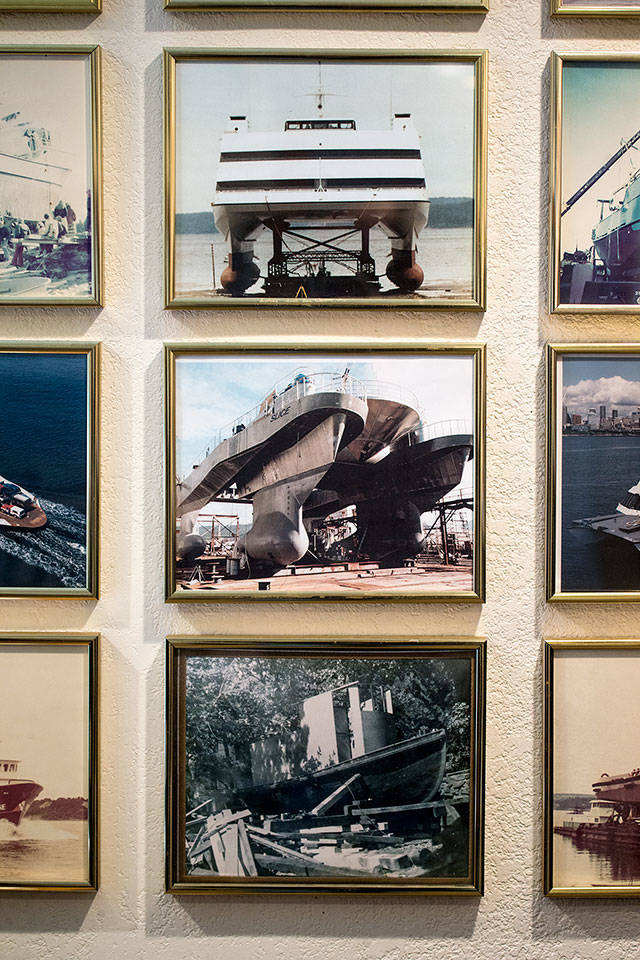 Pictures on an office wall at Nichols Brothers Boat Builders in Freeland show the first tug built, at bottom, and vessels Sea Slice, middle, and Cloud 10. (Andy Bronson / The Herald)
