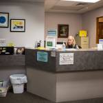 Kathy Kerkvliet sits at the front desk of the Safe Harbor Clinic in Stanwood. (Olivia Vanni / The Herald)