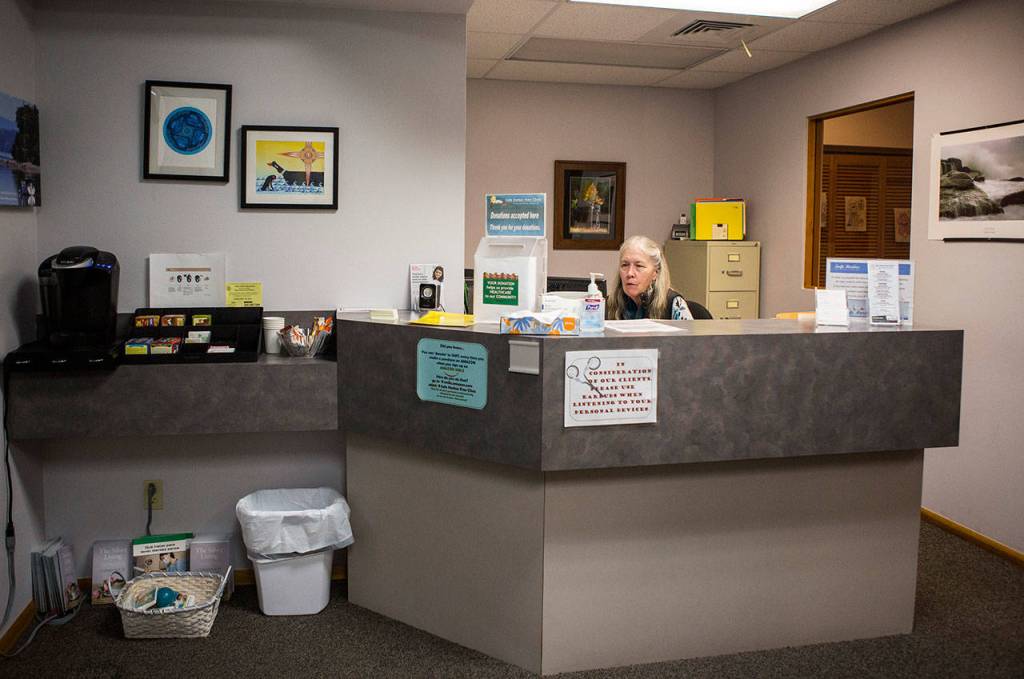 Kathy Kerkvliet sits at the front desk of the Safe Harbor Clinic in Stanwood. (Olivia Vanni / The Herald)