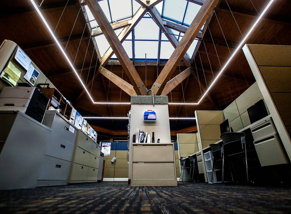 A huge skylight and large light bars wrap around the work area near the center of Homage Senior Services in Lynnwood. (Dan Bates / The Herald)