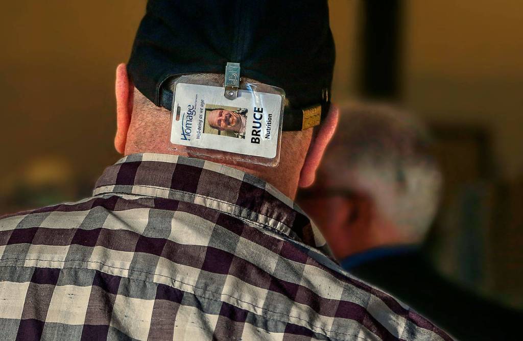 Thats using his head. Delivery driver Bruce Rhodes wears his photo ID where clients can easily see he is with Meals on Wheels. (Dan Bates / The Herald)