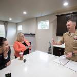 Heather and Tyler Ferrel chat with Courtney McClasky (center), a broker with Keller Williams North Sound Realty in Marysville, in the house they intend to buy in Marysville. (Andy Bronson / The Herald)