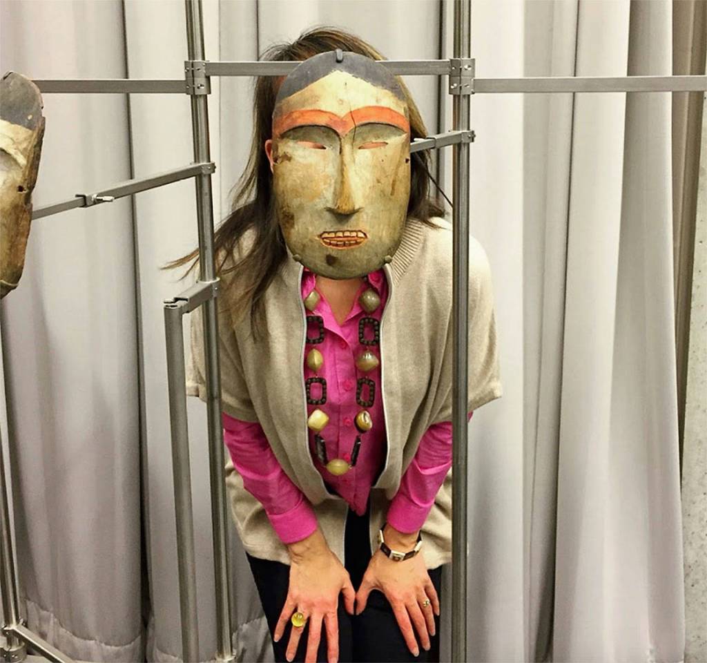 Susan Ringstad Emery spent several days at the Anchorage Museum studying artifacts from the Smithsonian Arctic Studies Center. Here, however, she is caught looking through an amazing mask.