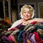 Snohomish artist Jackie Cort holds handmade hats for her annual sock-hat-scarf collection for two social service agencies in Everett. Cort, who gets hundreds of items every year from artists and friends, is having a donation drop-off night Friday that is open to the community. She started the mission some 20 years ago when her kids were little. They still help her with the project.