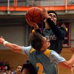 Everetts Taras Fesiienko (bottom) takes a charge on a drive by Cascades Cascades Davanta Murphy-McMillan during the annual BruGull Fest game between the cross-town rivals Friday at the Walt Price Student Fitness Center at Everett Community College. (Kevin Clark / The Herald)