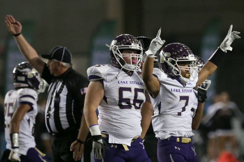 Lake Stevens Isaiah Harris (right) celebrates a fumble recovery in the first quarter against Union in the 4A state football championship game on Dec. 1, 2018, at the Tacoma Dome. (Kevin Clark / The Herald)