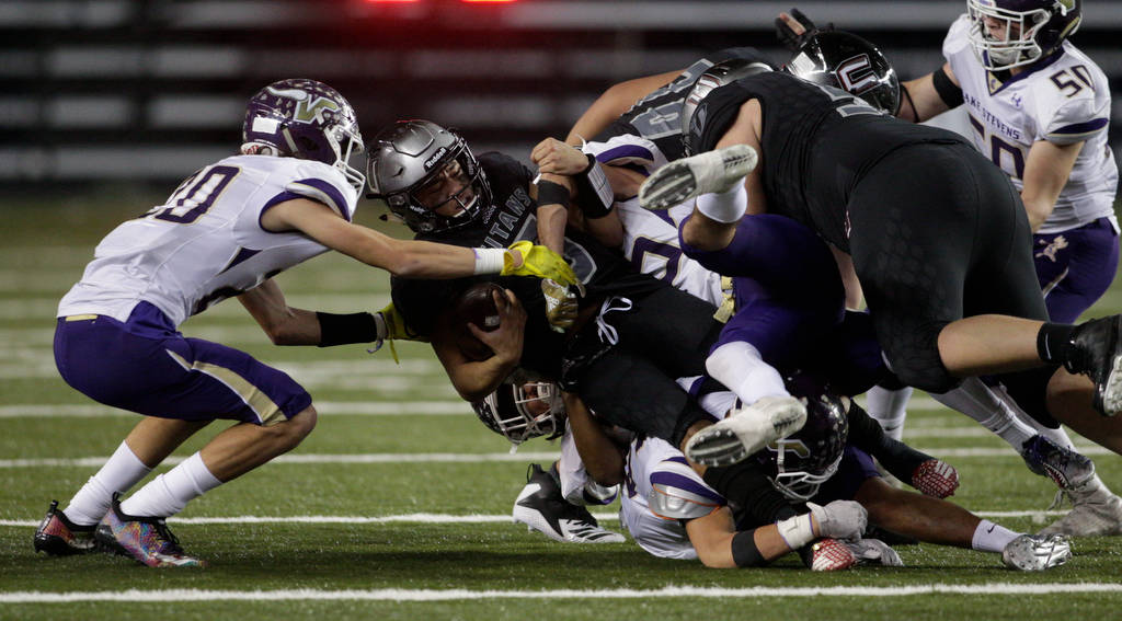 Unions Lincoln Victor is taken down by the Vikings defense, but not before gaining a first down as Lake Stevens lost to Union 52-20 in the 4A state football championship game on Dec. 1, 2018, at the Tacoma Dome. (Andy Bronson / The Herald)