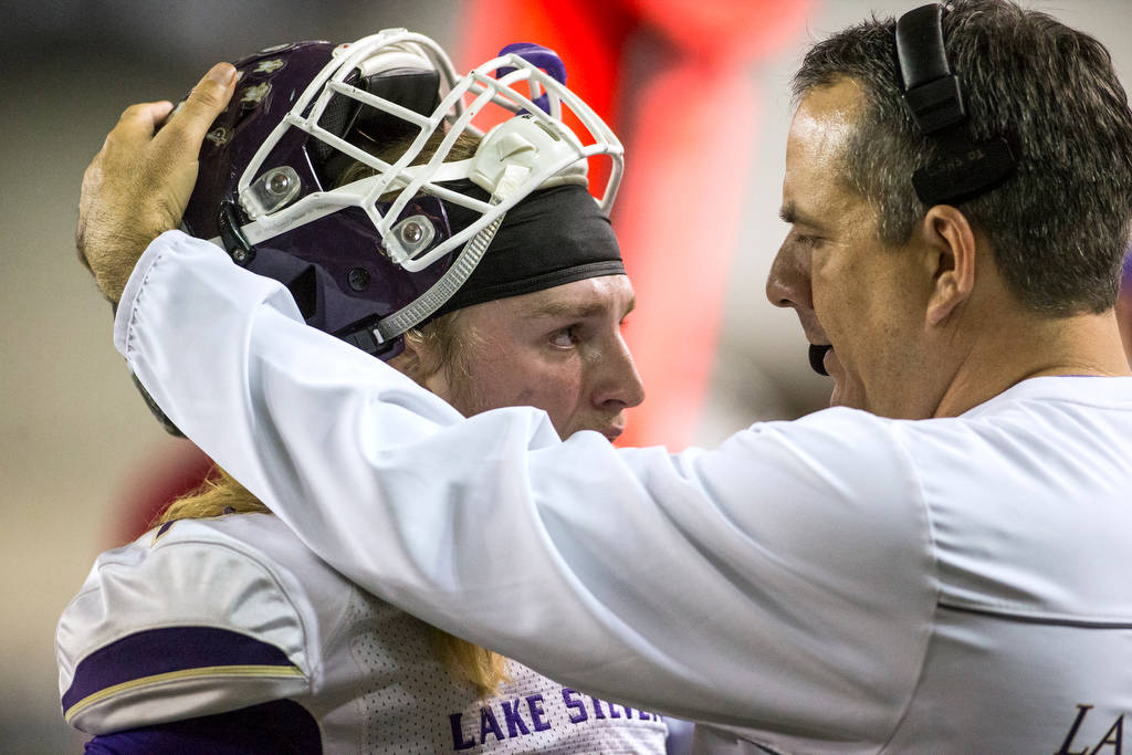 Lake Stevens head coach Thomas Tri consoles quarterback Tre Long near the end of the game as the Vikings lost to Union 52-20 in Washington Div. 4A high school football championship, Saturday, Dec. 1, 2018, in Tacoma, Wash. (Andy Bronson / The Herald via AP)