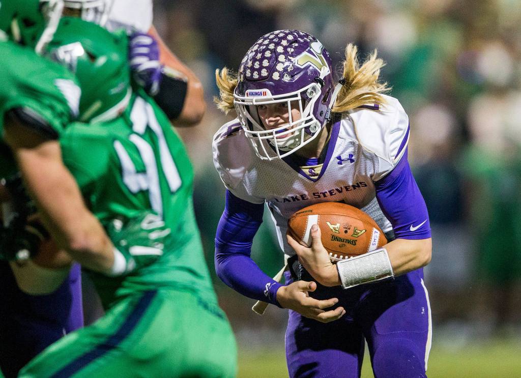 Lake Stevens Tre Long runs the ball during the Class 4A state state semifinal game against Woodinville at Pop Keeney Stadium on Nov. 24 in Bothell. (Olivia Vanni / The Herald)