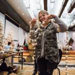 Designer Jana Johnson laughs as she tries to untangle a sting of garland balls while decorating a tree for the auction at the 2018 <a href="https://www.heraldnet.com/news/take-in-the-delights-at-annual-festival-of-trees/" target="_blank">Festival of Trees</a> held in Tulalip Resort Casino on Nov. 26. (Andy Bronson / The Herald)