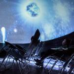 People look up at the projection inside the <a href="https://www.heraldnet.com/news/journey-into-space-from-a-lawn-chair-at-the-mall/" target="_blank">Planetarium 360</a> before the start of the show at the Everett Mall on Nov. 24. (Olivia Vanni / The Herald)