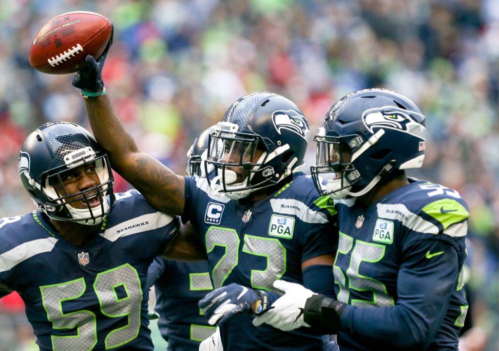 Seahawks corner back Neiko Thorpe (center) celebrates a fumble Sunday afternoon at CenturyLink Field in Seattle on December 2, 2018. Seahawks won 46-16. (Kevin Clark / The Herald)
