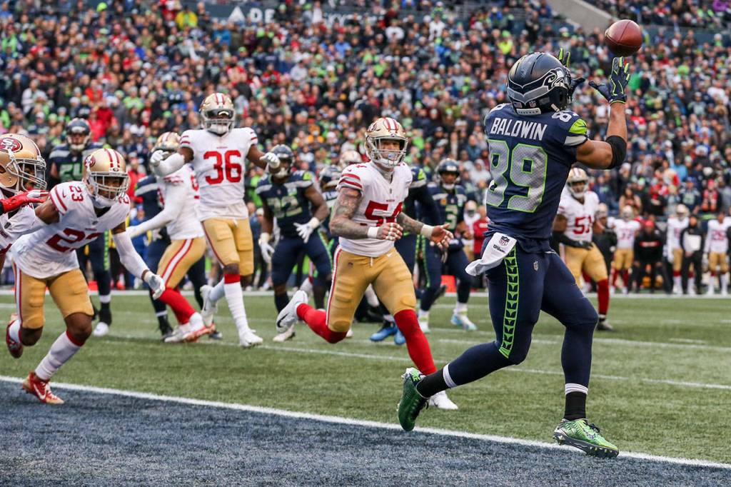 Seahawks wide receiver Doug Baldwin makes a touchdown reception with 49ers defenders trailing Sunday afternoon at CenturyLink Field in Seattle on December 2, 2018. Seahawks won 46-16. (Kevin Clark / The Herald)