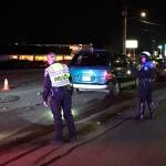 Police officers investigate a crash of several vehicles that seriously injured someone Monday, Dec. 3 on Highway 99 near 234th Street SW in Edmonds. The alleged at-fault driver ran away. (Edmonds Police Department)