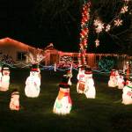 Blow-mold snowmen are among the first things visitors see when they visit the Becks annual Christmas light show. (Kevin Clark / The Herald)