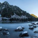 Snow and a solid layout of ice cover the banks of Heather Lake on Wednesday, Dec. 5, 2018 in Granite Falls, Wa. (Olivia Vanni / The Herald)