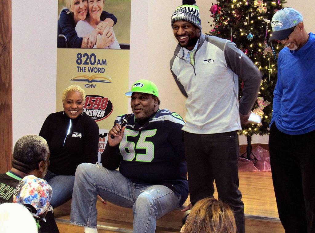 Former Seahawk Edwin Bailey (with microphone) answers questions, providing spontaneous entertainment for fans along with his wife Toni (left) and other former Seahawks Jordan Babineaux (center) and Paul Johns (right). (Contributed Photo)