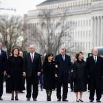 From right, former President George W. Bush, former first lady Laura Bush, Neil Bush, Sharon Bush, Bobby Koch, Doro Koch, Jeb Bush and Columba Bush, stand just prior to the flag-draped casket of former President George H.W. Bush being carried by a joint services military honor guard from the U.S. Capitol on Wednesday in Washington. (AP Photo/Alex Brandon, Pool)