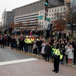 People watch as the hearse carrying the flag-draped casket of former President George H.W. Bush passes Freedom Plaza on its way to a State Funeral at the National Cathedral on Wednesday in Washington. (AP Photo/Alex Brandon, Pool)