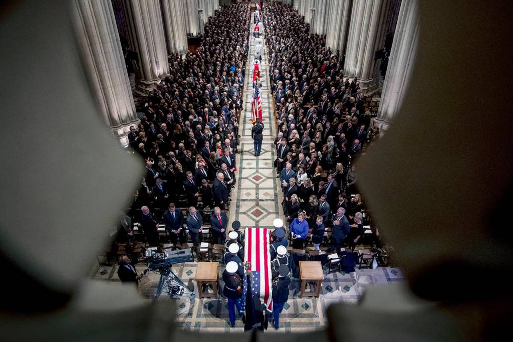 The flag-draped casket of former President George H.W. Bush is carried by a military honor guard during a State Funeral at the National Cathedral on Wednesday in Washington. (AP Photo/Andrew Harnik, Pool)
