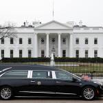 The hearse carrying the flag-draped casket of former President George H.W. Bush passes by the White House from the Capitol, heading to a State Funeral at the National Cathedral on Wednesday in Washington. AP Photo/Jacquelyn Martin)