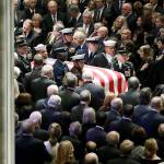 The flag-draped casket of former President George H.W. Bush is carried by a military honor guard during a State Funeral at the National Cathedral on Wednesdayin Washington. (AP Photo/Evan Vucci)