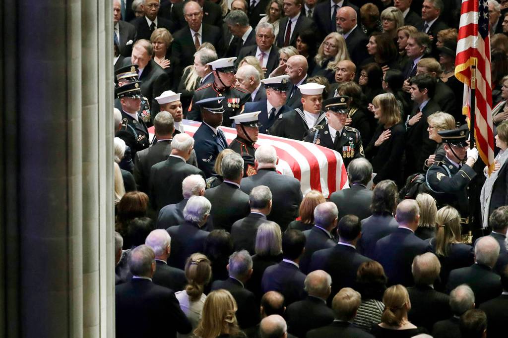 The flag-draped casket of former President George H.W. Bush is carried by a military honor guard during a State Funeral at the National Cathedral on Wednesdayin Washington. (AP Photo/Evan Vucci)
