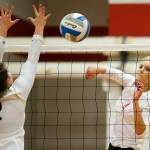 Stanwoods Devon Martinka (right) spikes a ball past Arlingtons Caroline Diemer during a game Oct. 17, 2017, at Stanwood High School. (Ian Terry / The Herald)