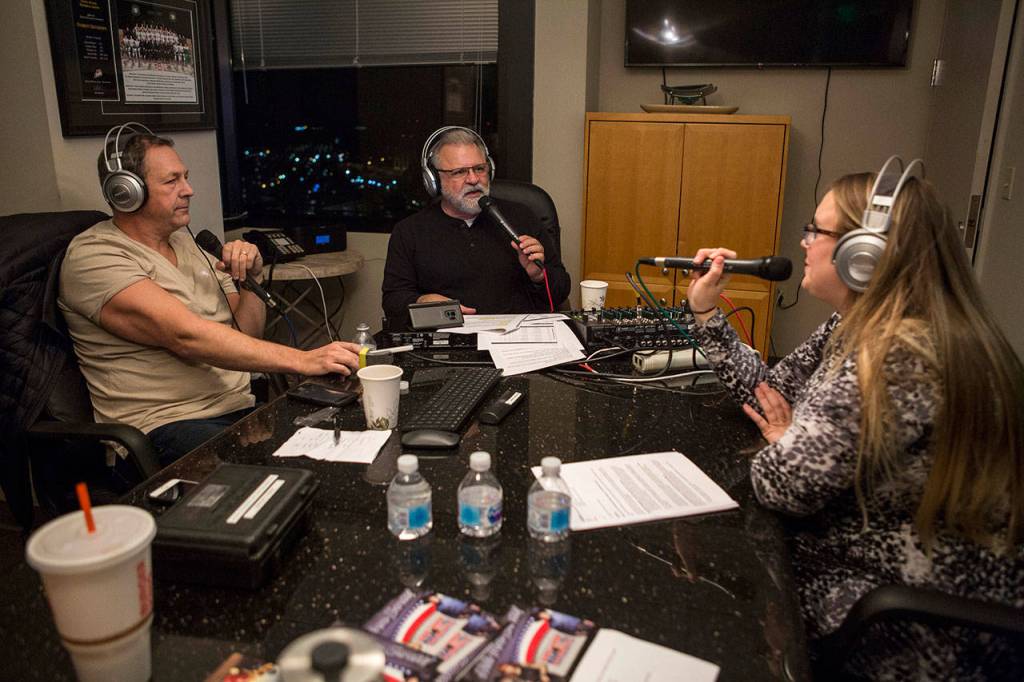 Mark Brinkman, Maury Eskenazi and State Farm agent Teri Busch talk during annual DUI radio show at the KRKO radio office in Everett. (Olivia Vanni / The Herald)