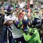 Seattle Seahawks cornerback Shaquill Griffin (26) breaks up a pass intended for Minnesota Vikings wide receiver Stefon Diggs (14) in the second half of an NFL football game, Monday, Dec. 10, 2018, in Seattle. The Seahawks won 21-7. (AP Photo/Ted S. Warren)