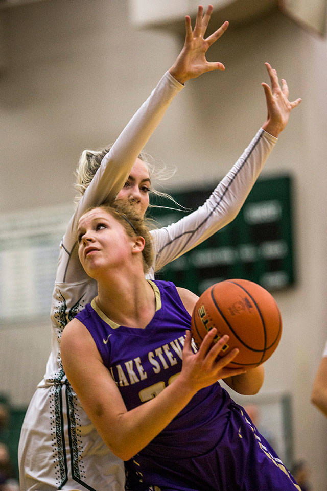 Lake Stevens Cori Wilcox tries to get around Jacksons Lauren Schillberg during Tuesdays game in Mill Creek. (Olivia Vanni / The Herald)