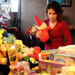 Lettia Burch sorts through toy donations on Saturday, Dec. 15, at Twin Foxes in Everett. (Kevin Clark / The Herald)
