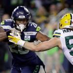 Seahawks running back Rashaad Penny (left) tries to get around Packers linebacker Clay Matthews during a game on Nov. 15, 2018, in Seattle. (AP Photo/Elaine Thompson)