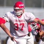 Cade Tucker blocks during practice Sept. 6, at Quil Ceda Stadium in Marysville. (Kevin Clark / The Herald)
