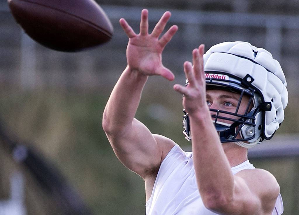 Evan Mannes eyes the incoming pass during practice Oct. 4, at Glacier Peak High School in Snohomish. (Kevin Clark / The Herald)