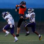 Monroes Efton Chism hauls in a pass between two defenders as Lake Stevens led Monroe 35-14 late in the second quarter Sept. 14, in Monroe. (Andy Bronson / The Herald)