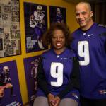 Robbie and Scott Gaskin, parents of University of Washington Husky football running back Myles Gaskin, stand near some memorabilia of his record-setting career at their home in Lynnwood. The family is in Pasadena this week to watch him play in the Rose Bowl. (Olivia Vanni / The Herald)