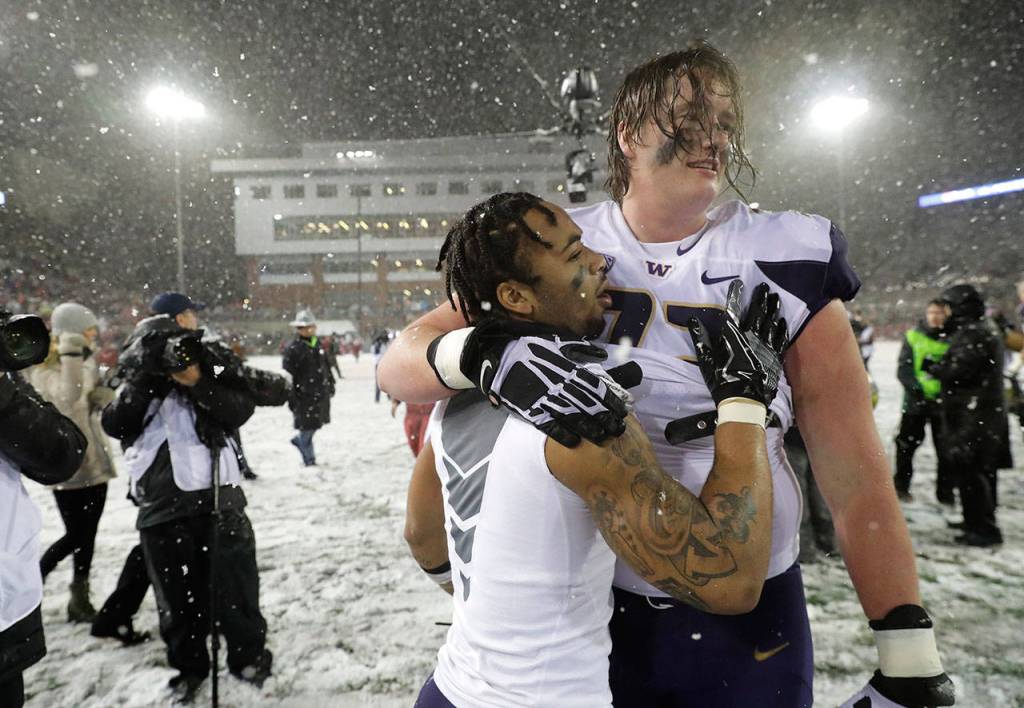 Washington running back Myles Gaskin (left) celebrates with offensive lineman Trey Adams after Washington defeated Washington State 28-15 in an NCAA college football game on Nov. 23 in Pullman. (Ted S. Warren / AP file)