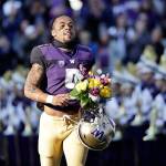 Washingtons Myles Gaskin runs past the Husky Marching Band as he is introduced with other seniors before an NCAA college football game against Oregon State on Nov. 17 in Seattle. (Elaine Thompson / AP file)