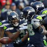 Seahawks wide receiver Jaron Brown (center) celebrates with wide receiver David Moore (left) and offensive tackle Duane Brown (right) after catching a touchdown during the second half of a game against the 49ers on Dec. 2, 2018, in Seattle. (AP Photo/Elaine Thompson)