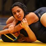 Arlingtons Hanah Crew (bottom) wrestles Cascades Alethea Valenzuela on Wednesday at Mariner High School in Everett. (Kevin Clark / The Herald)