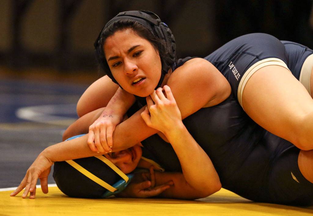 Arlingtons Hanah Crew (bottom) wrestles Cascades Alethea Valenzuela on Wednesday at Mariner High School in Everett. (Kevin Clark / The Herald)