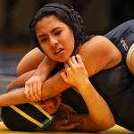 Arlingtons Hanah Crew (bottom) wrestles Cascades Alethea Valenzuela Wednesday night at Mariner High School in Everett on December 19, 2018. (Kevin Clark / The Herald)