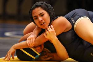 Arlingtons Hanah Crew (bottom) wrestles Cascades Alethea Valenzuela Wednesday night at Mariner High School in Everett on December 19, 2018. (Kevin Clark / The Herald)