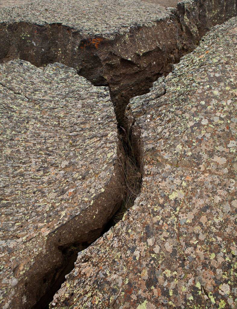 Earthquake cracks in lava, lichen on top. (Herald file)